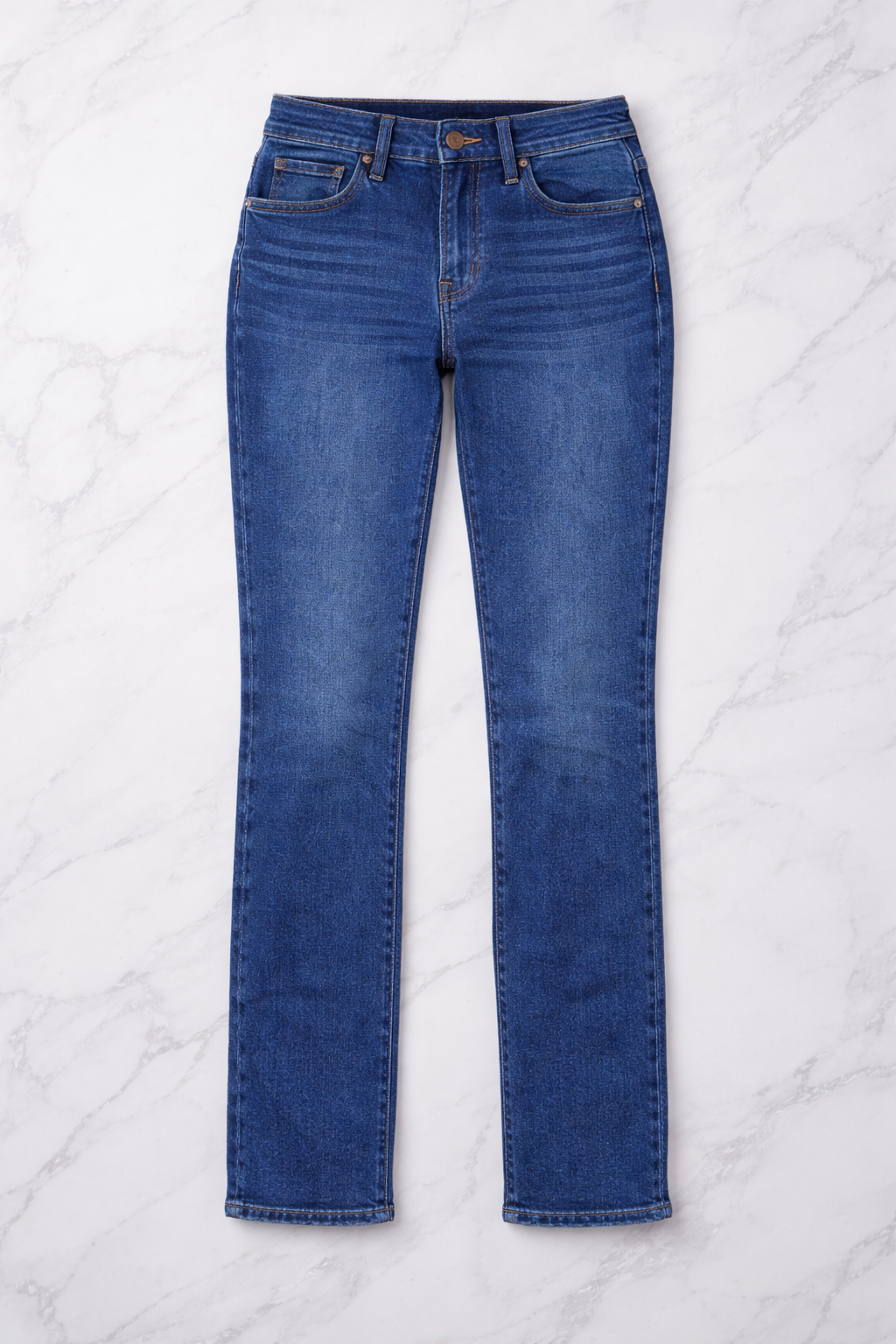 Blue jeans on a white marble surface