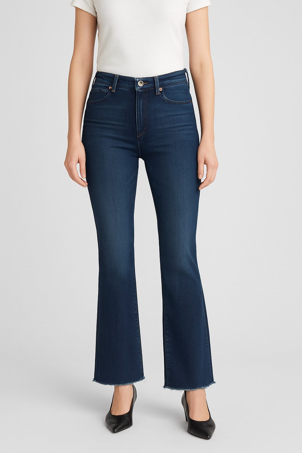 Person wearing dark blue jeans on a light gray background