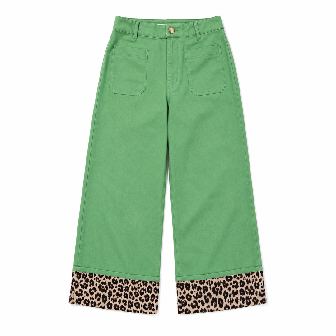 Green cropped pants with leopard print cuffs, shown flat against a white background.