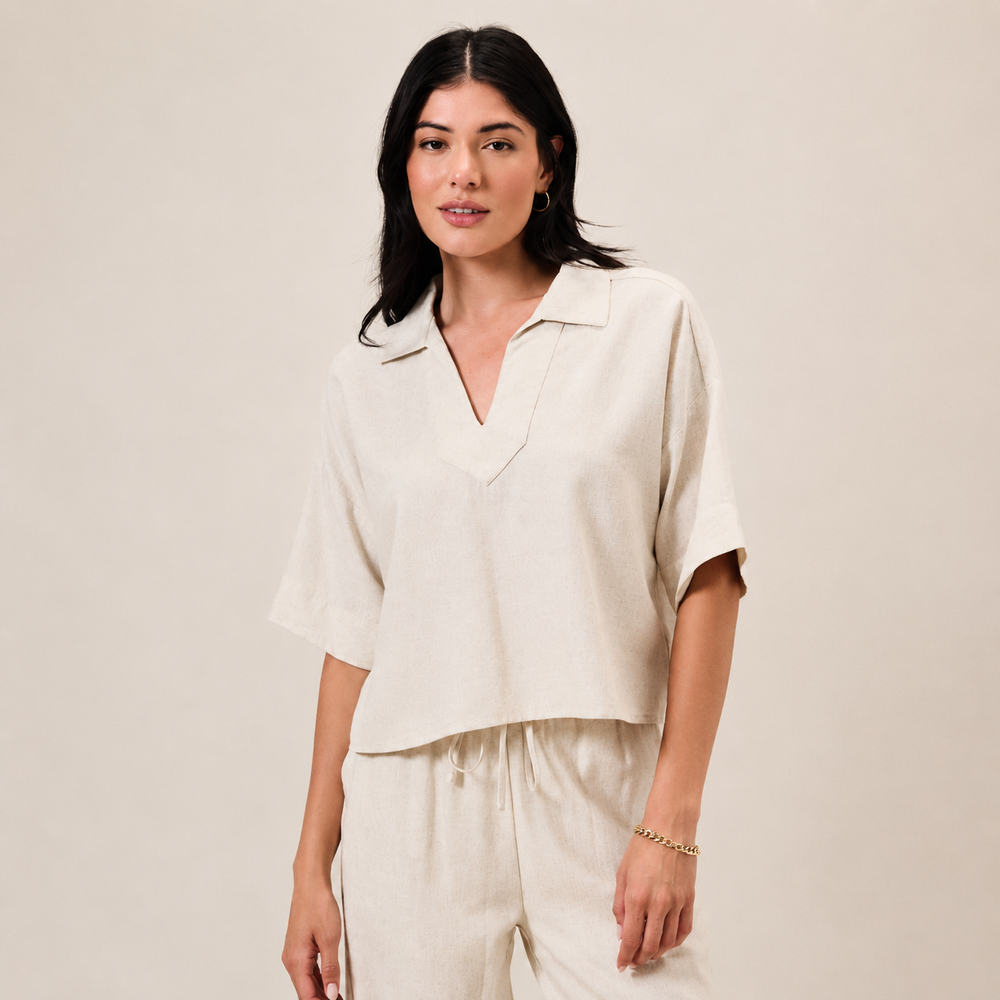 Woman wearing a beige outfit against a plain background