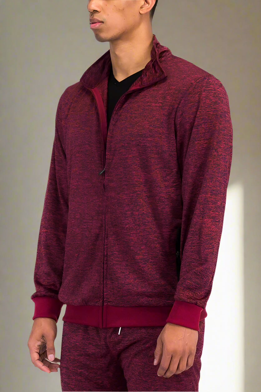 Maroon tracksuit worn by a person on a white background