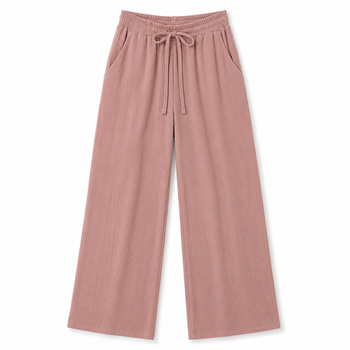 A pair of dusty rose wide-leg pants with an elastic waistband and drawstring, displayed flat against a solid white background.