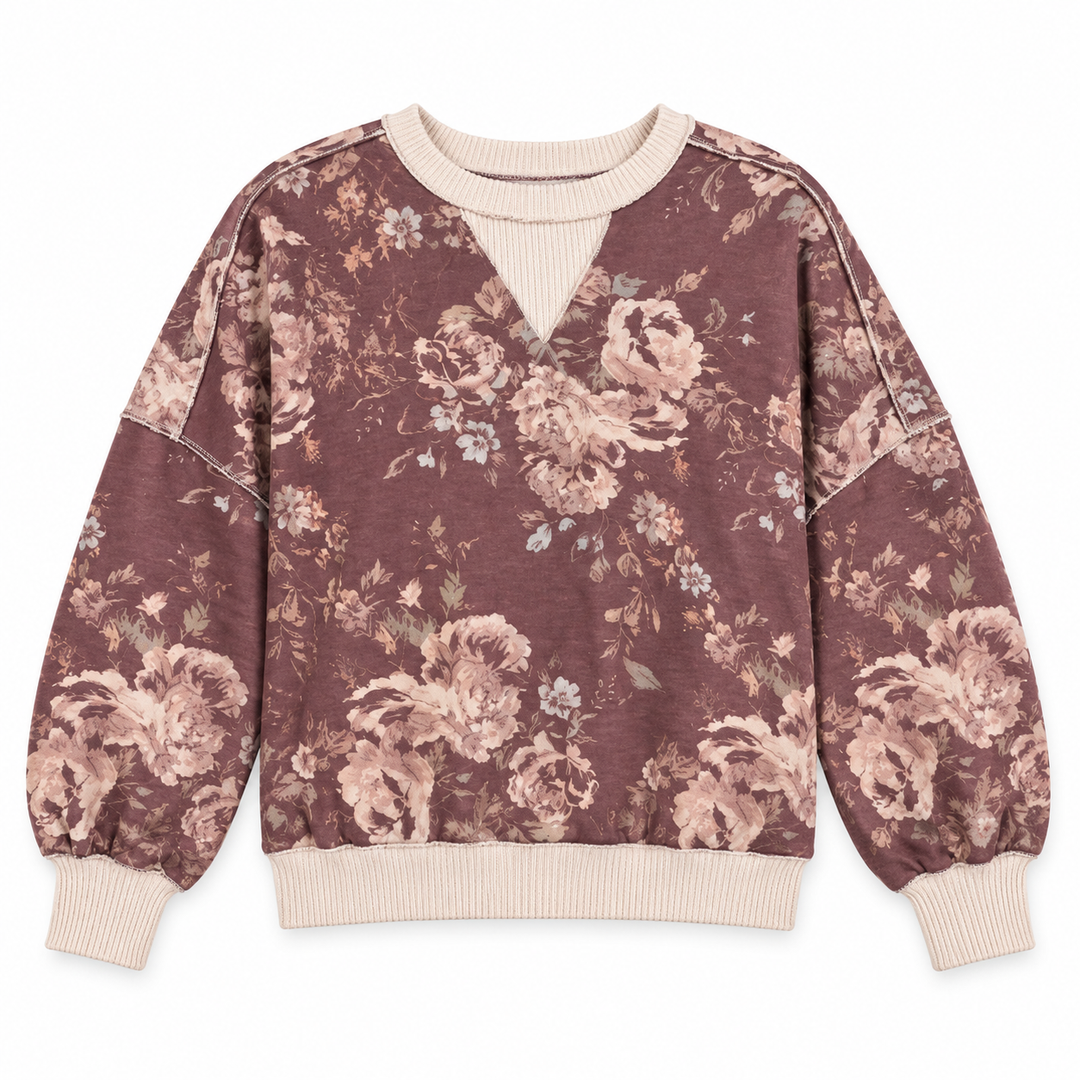 A long-sleeve crewneck sweatshirt featuring a dusty rose and beige floral print with ribbed cream trim at the collar, cuffs, and hem.
