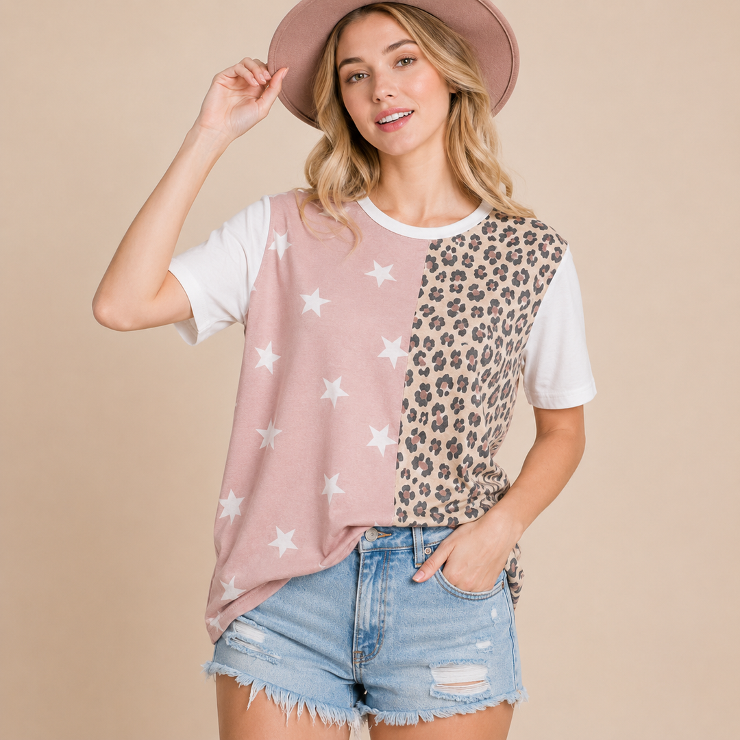 Woman wearing a two-tone shirt with star and leopard print patterns on a beige background