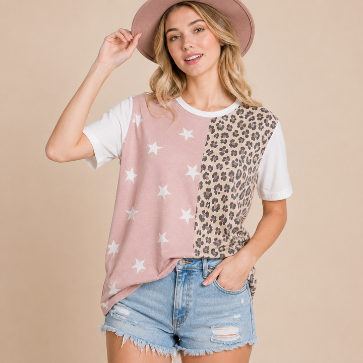 Woman wearing a two-tone shirt with star and leopard print patterns on a beige background
