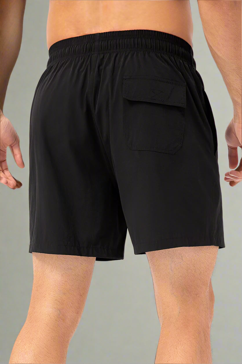 Black shorts worn by a person on a white background