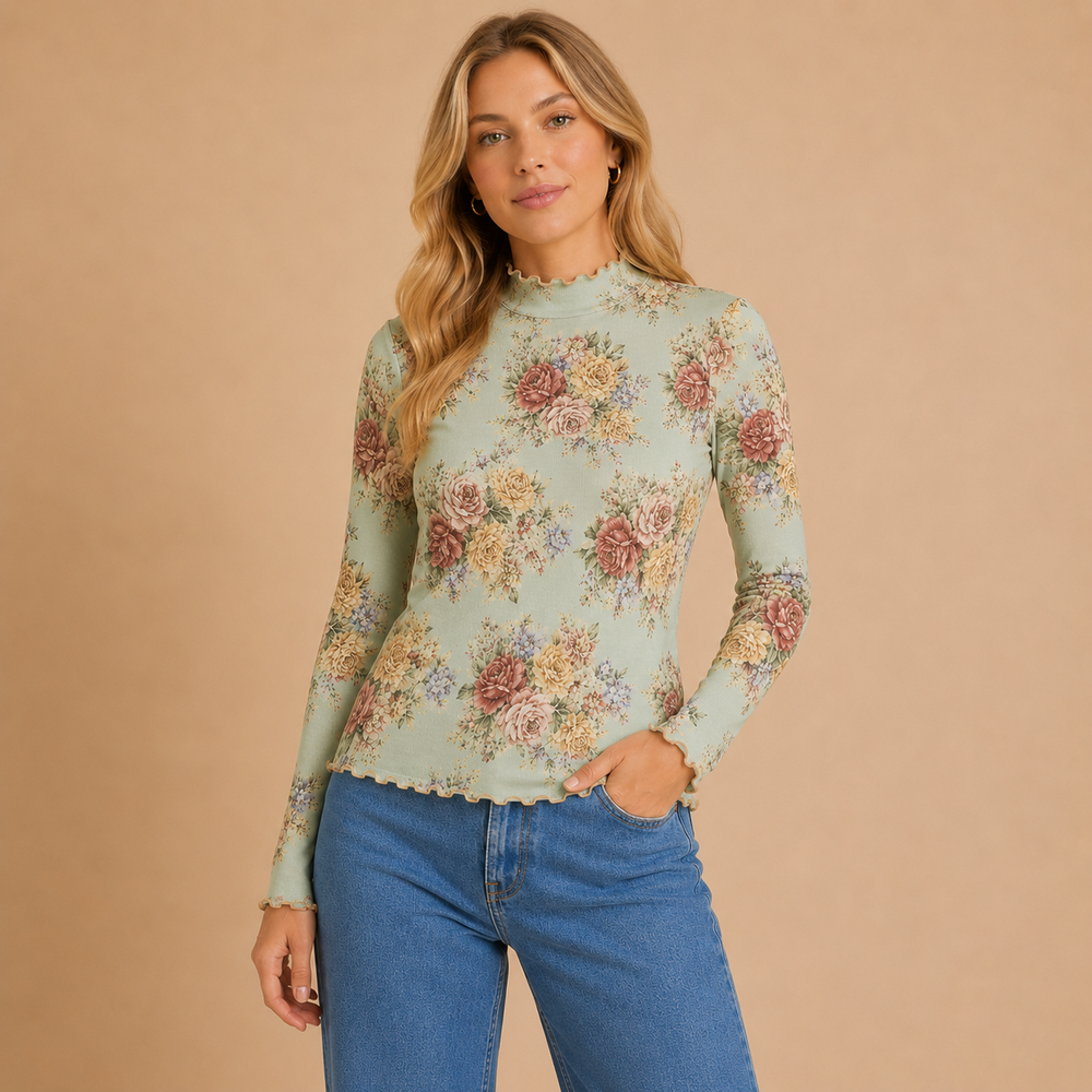Woman wearing a floral long-sleeve top and blue jeans against a beige background