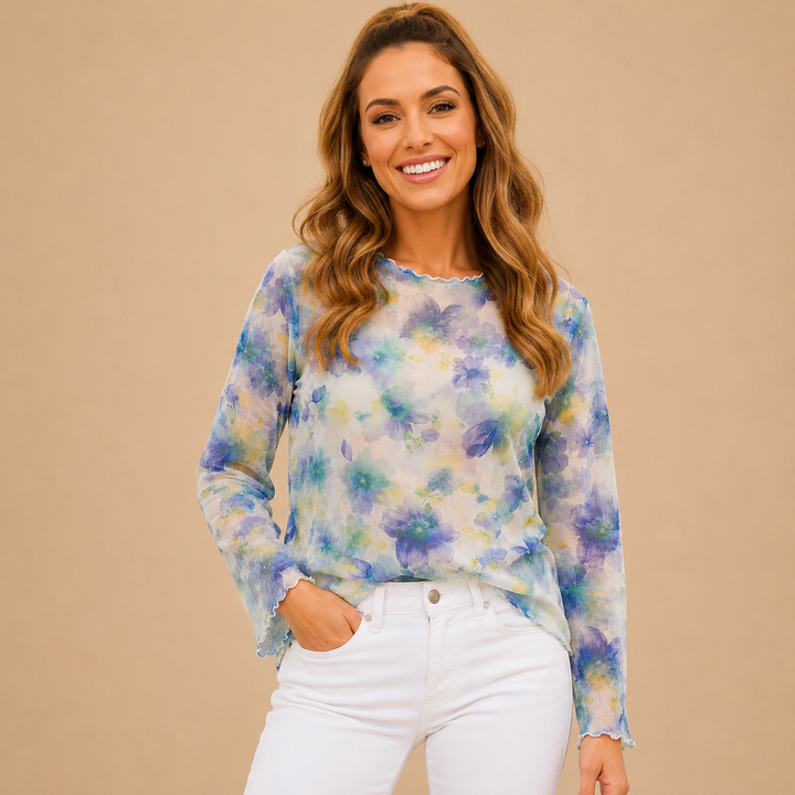 Woman wearing a floral long-sleeve top against a beige background