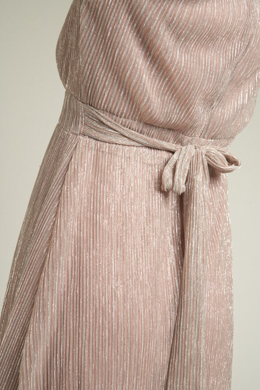 Close-up of a pink pleated dress with a tie waist on a light background