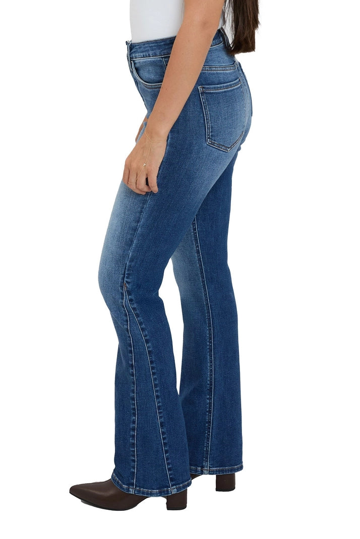 Blue flared jeans worn by a person on a white background