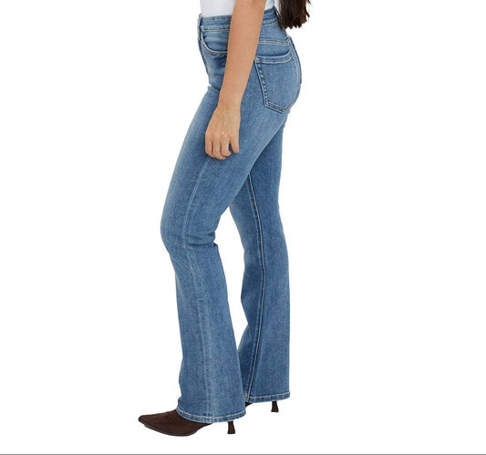 Woman wearing blue jeans and a white top on a white background