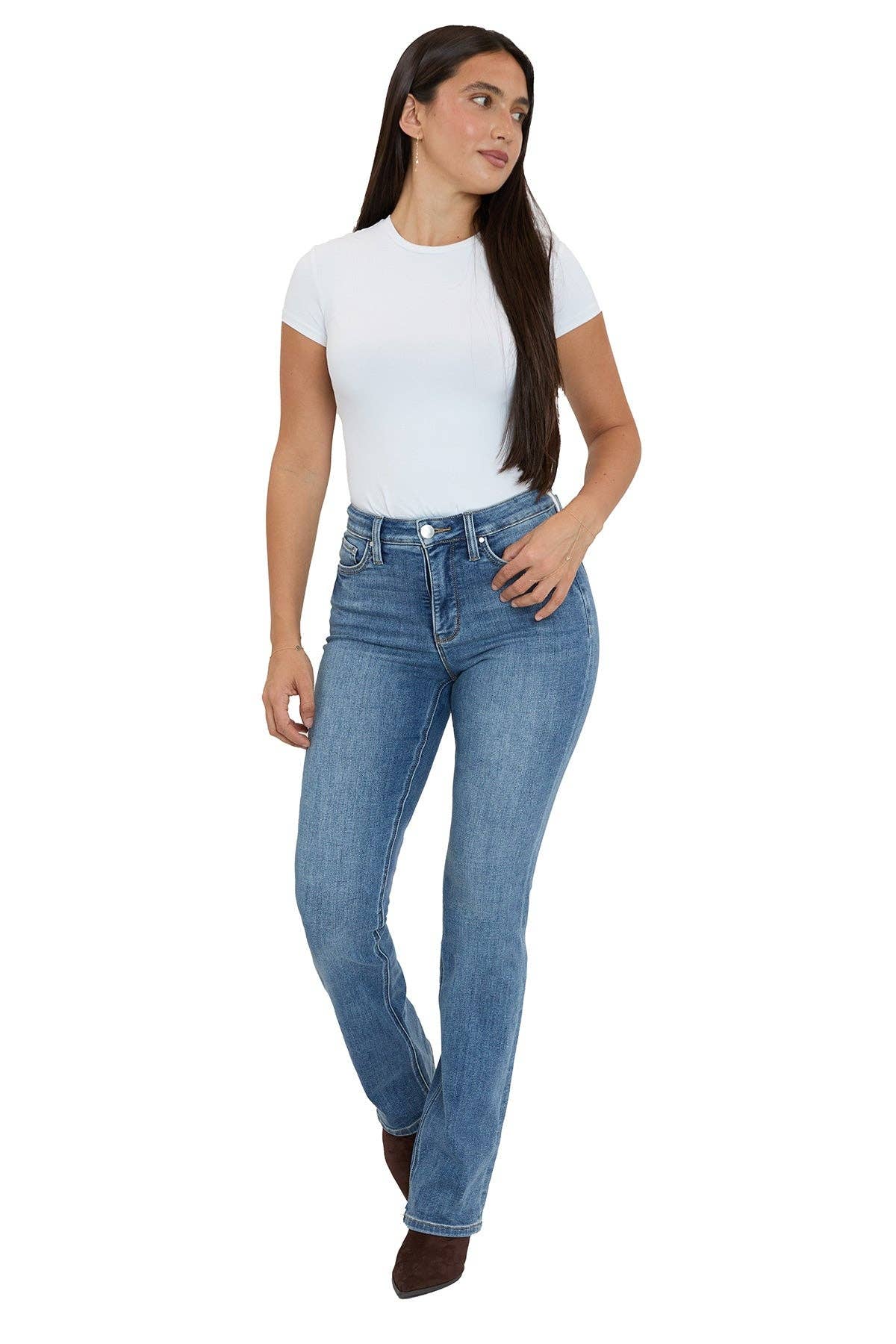 Woman wearing blue jeans and a white t-shirt on a white background