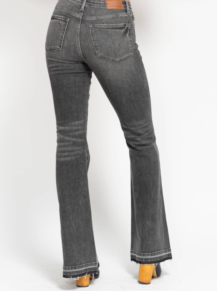 Grey flared jeans on a white background