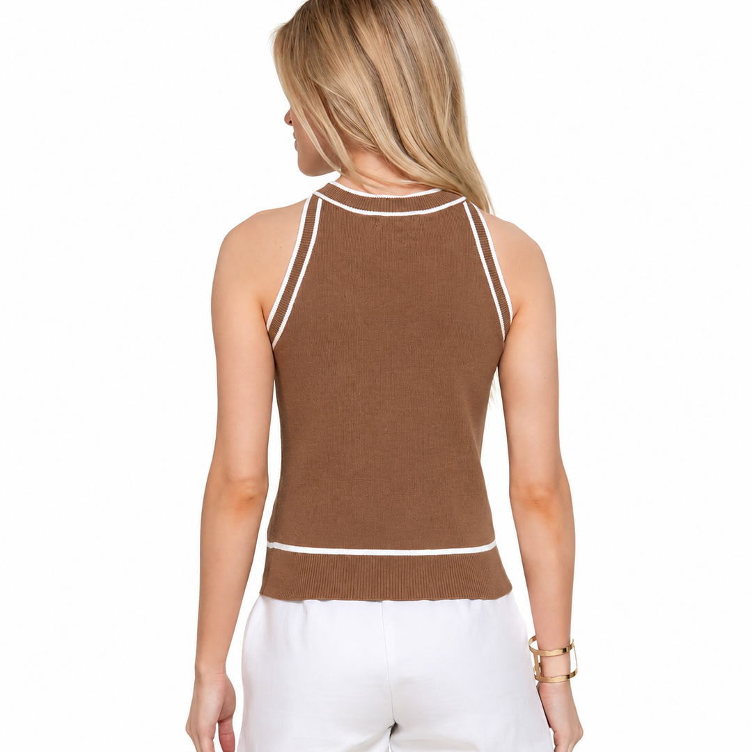 Woman wearing a brown sleeveless top with white trim on a white background