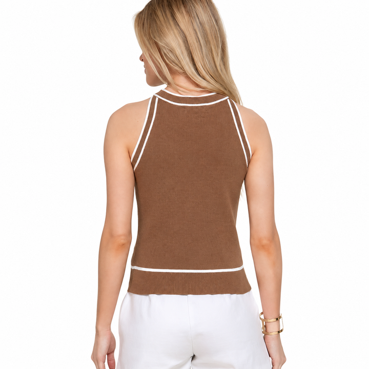 Woman wearing a brown sleeveless top with white trim on a white background