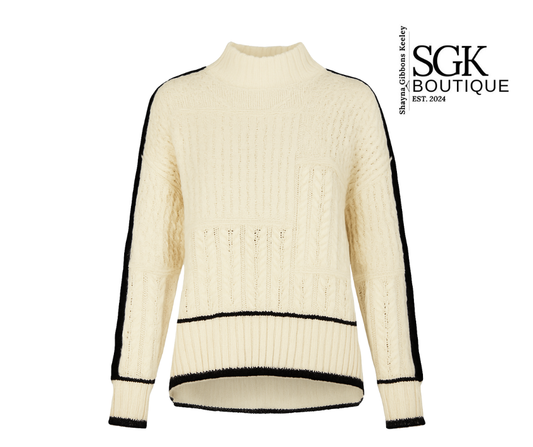 Cream-colored sweater with black accents on a white background, featuring the SGK Boutique logo.