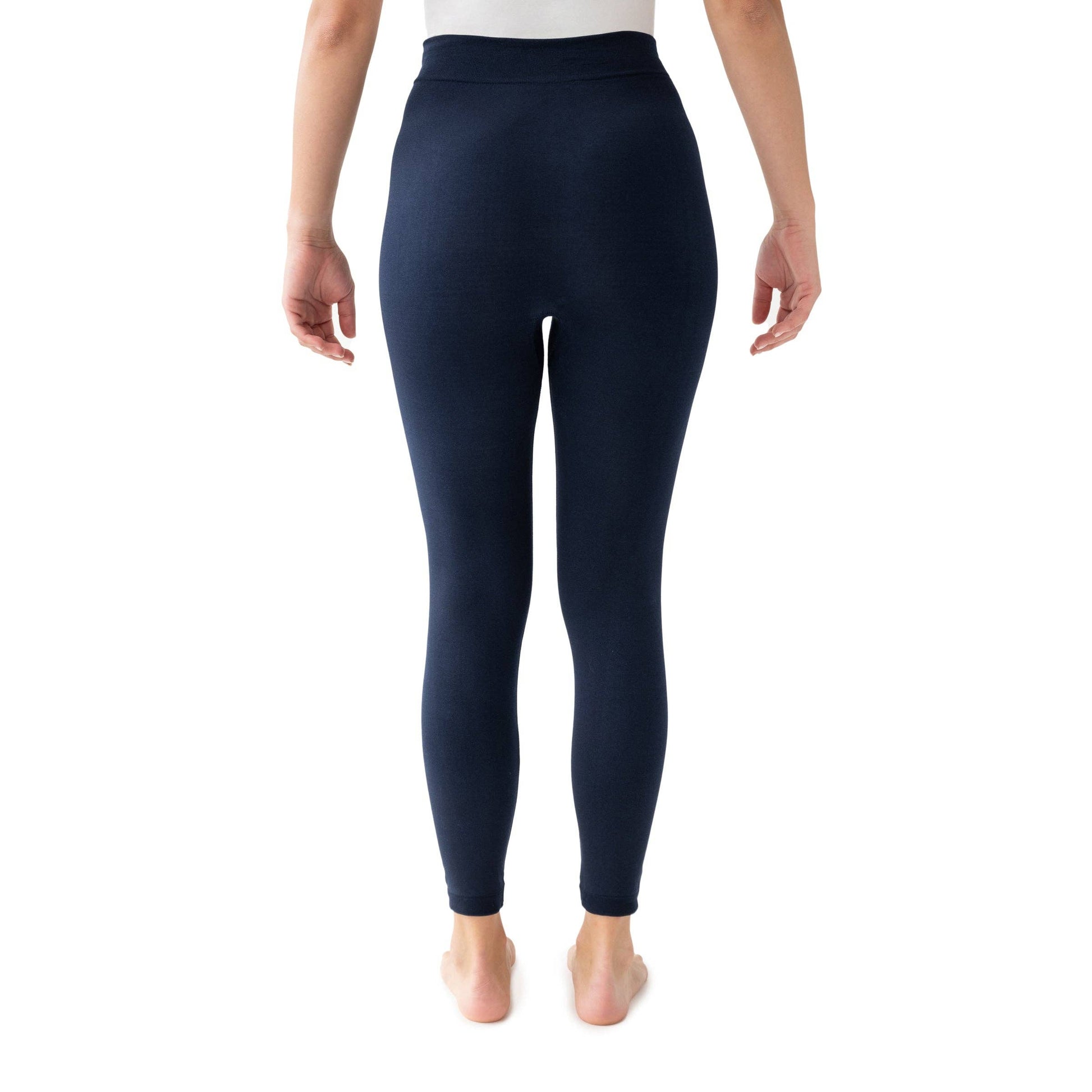 Navy leggings worn by a person on a white background