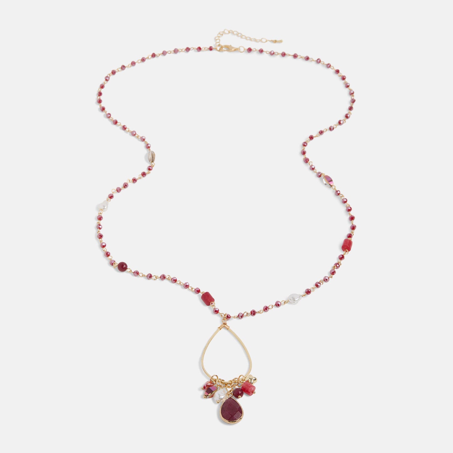 Necklace with red beads and a gold teardrop pendant on a white background