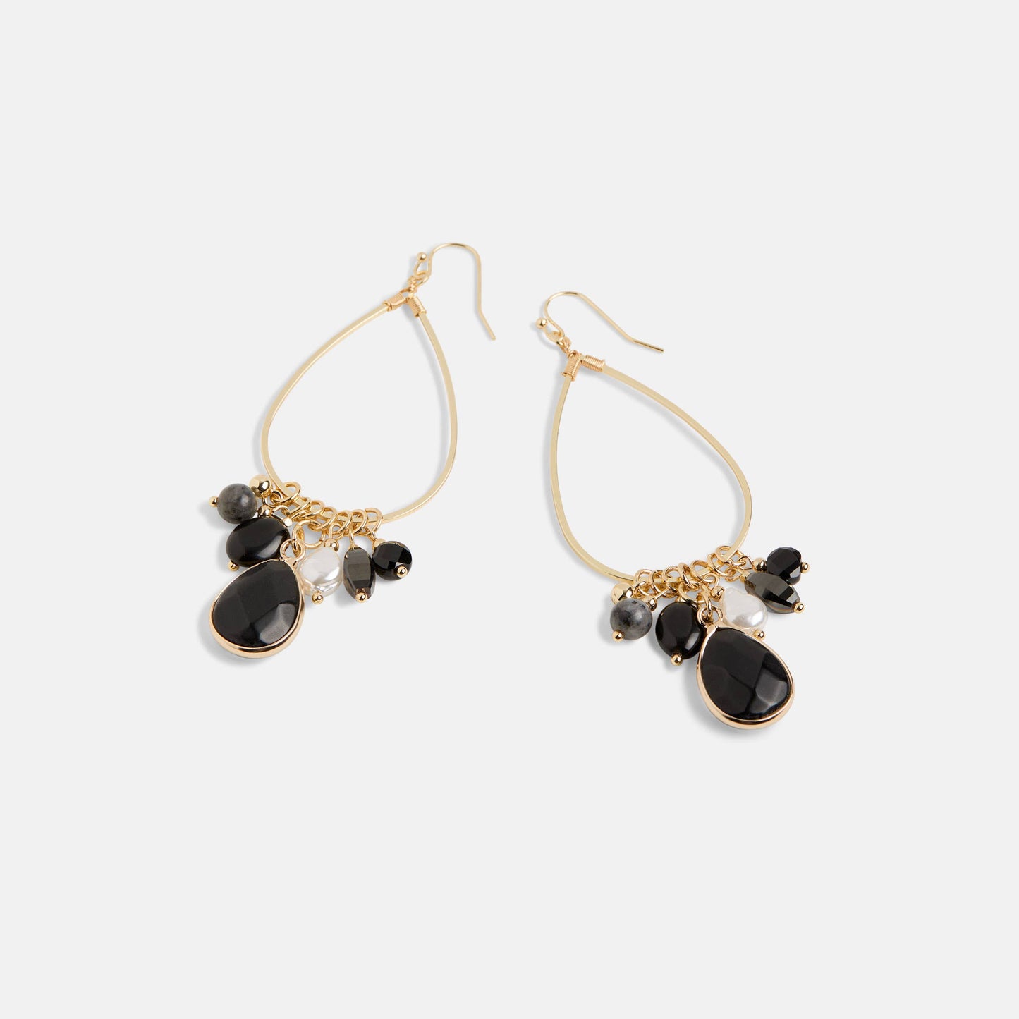 Gold earrings with black stones on a white background