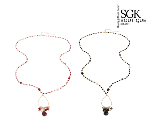 Two necklaces with red and black beads on a white background, featuring the SGK Boutique logo.