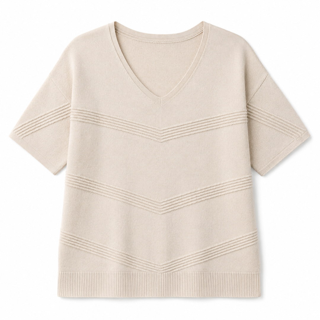 A short-sleeve knit V-neck sweater in a light cream or oatmeal color, featuring horizontal ribbed chevron patterns across the chest and sleeves, displayed on a clean white background.