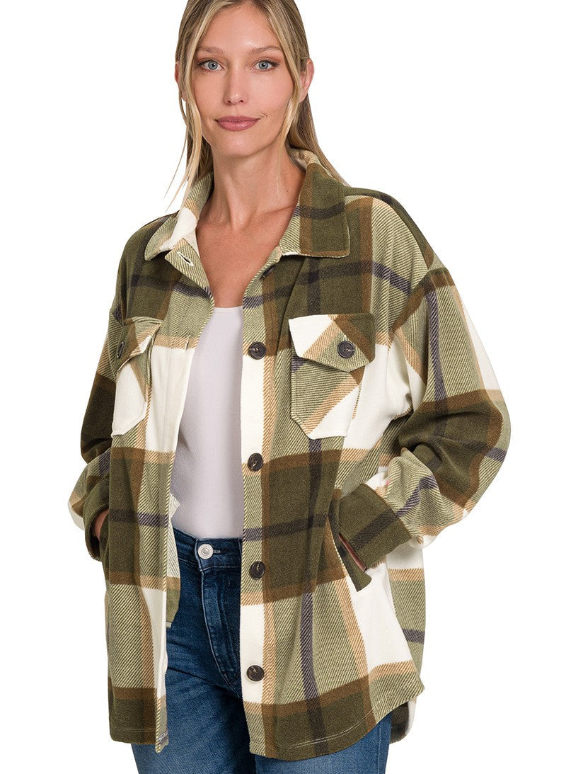 Woman wearing a plaid shirt with a white background