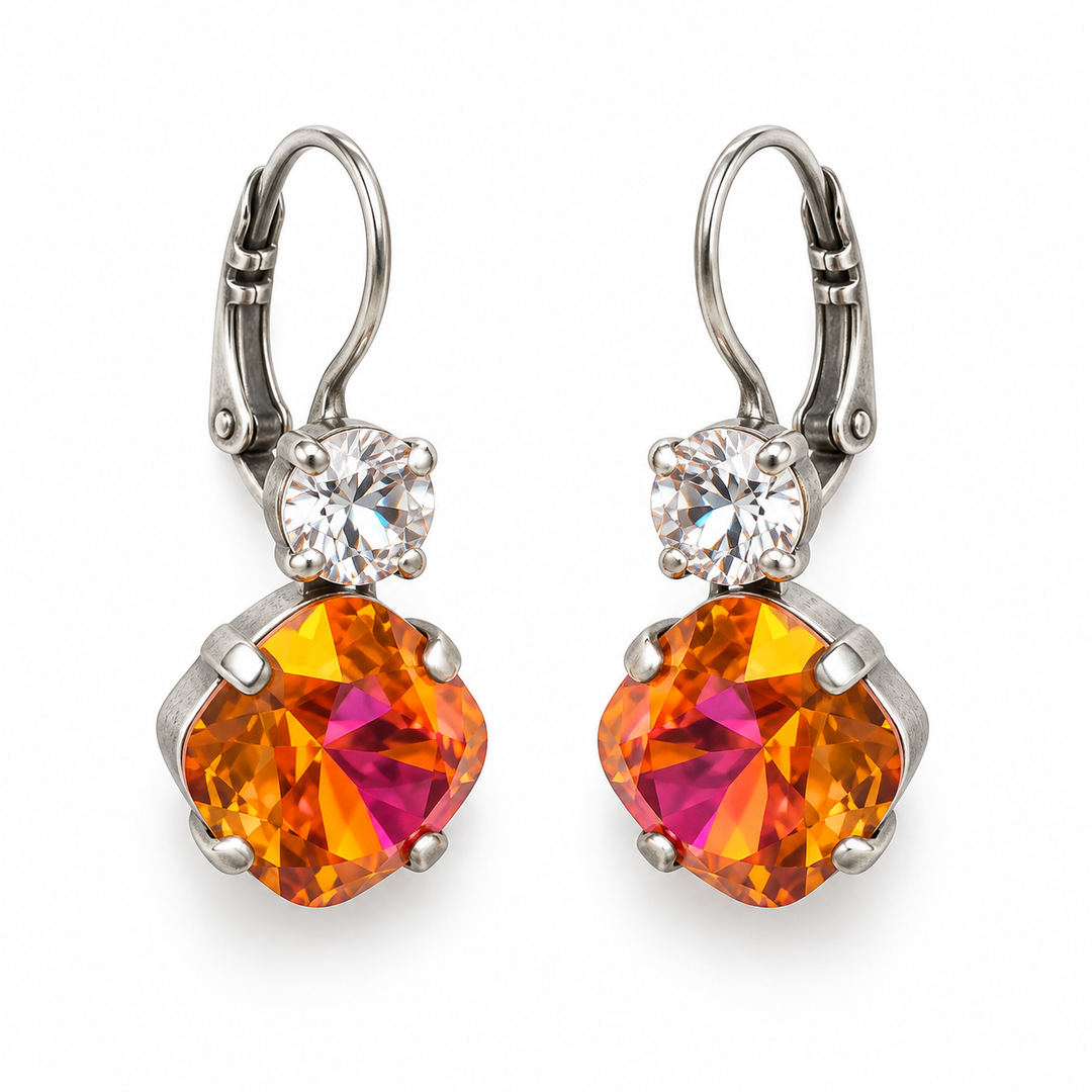 A pair of leverback earrings featuring large, faceted orange and magenta gradient marquise-cut crystals in silver settings, with a small clear round crystal above each larger stone, shown on a white background.