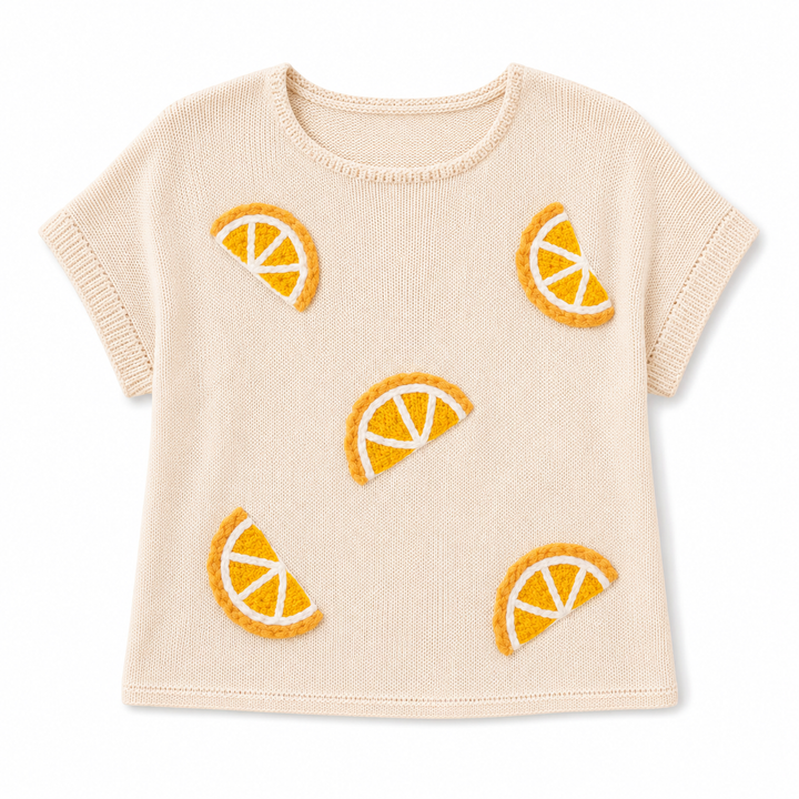 Beige knit sweater with orange slice patterns on a white background