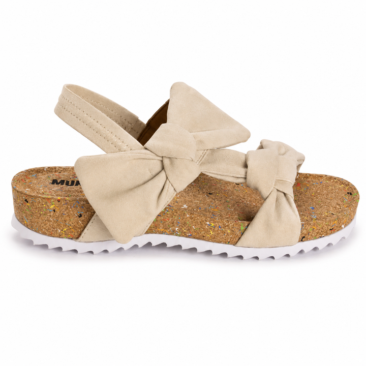 Beige sandal with bow design on a white background