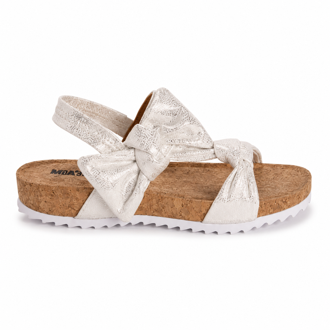 White sandal with cork sole and bow detail on a white background