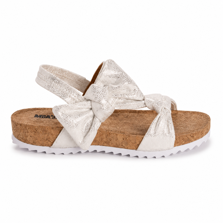 White sandal with cork sole and bow detail on a white background