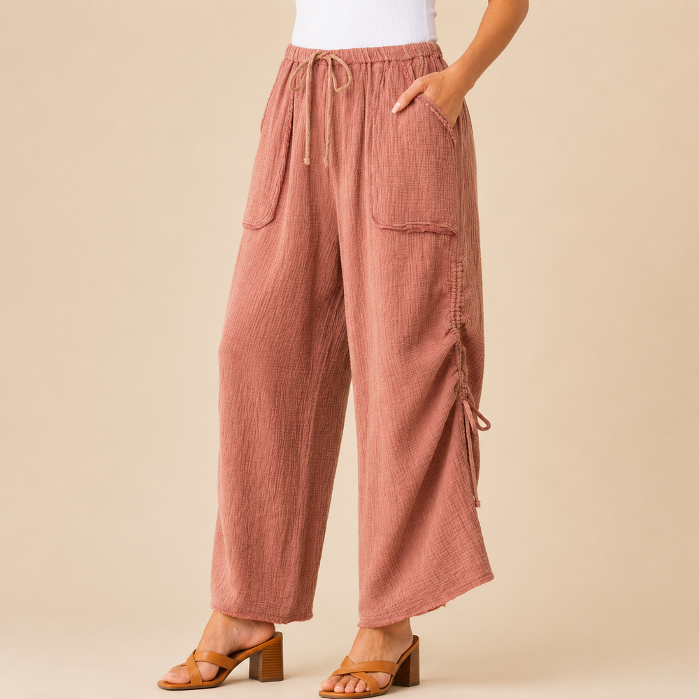 Pink pants worn by a person on a beige background