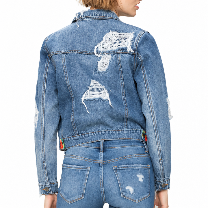 Blue denim jacket with white graphic designs on a white background