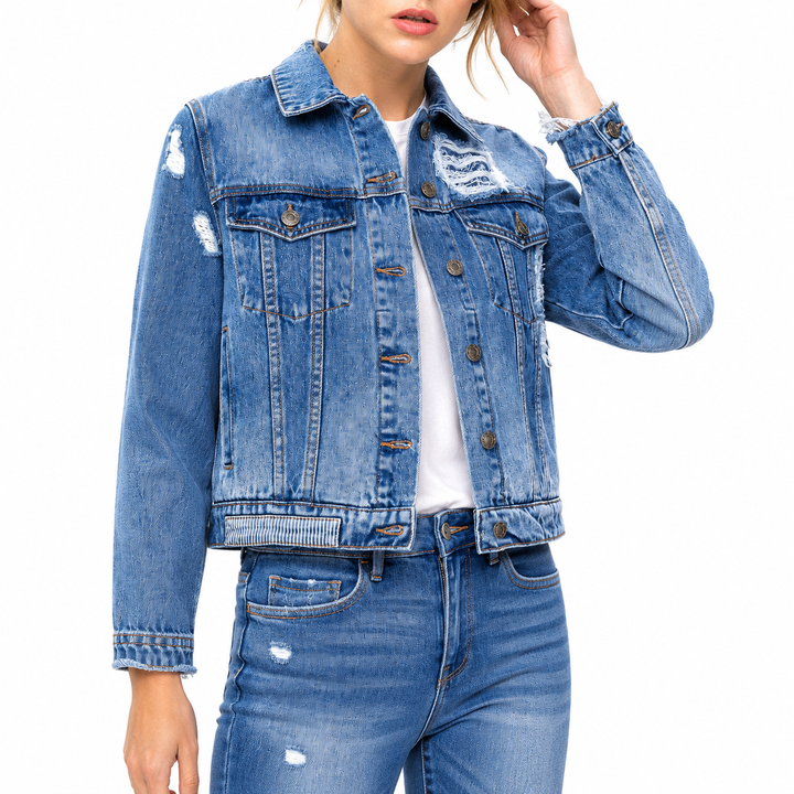 Person wearing a blue denim jacket and jeans on a white background