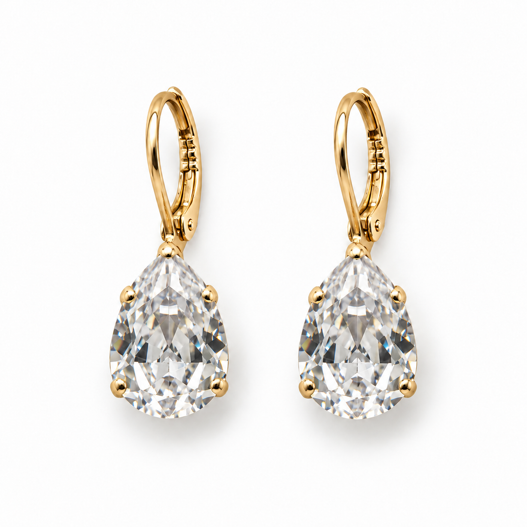 A pair of pear-cut diamond drop earrings in yellow gold leverback settings, shown on a clean white background.