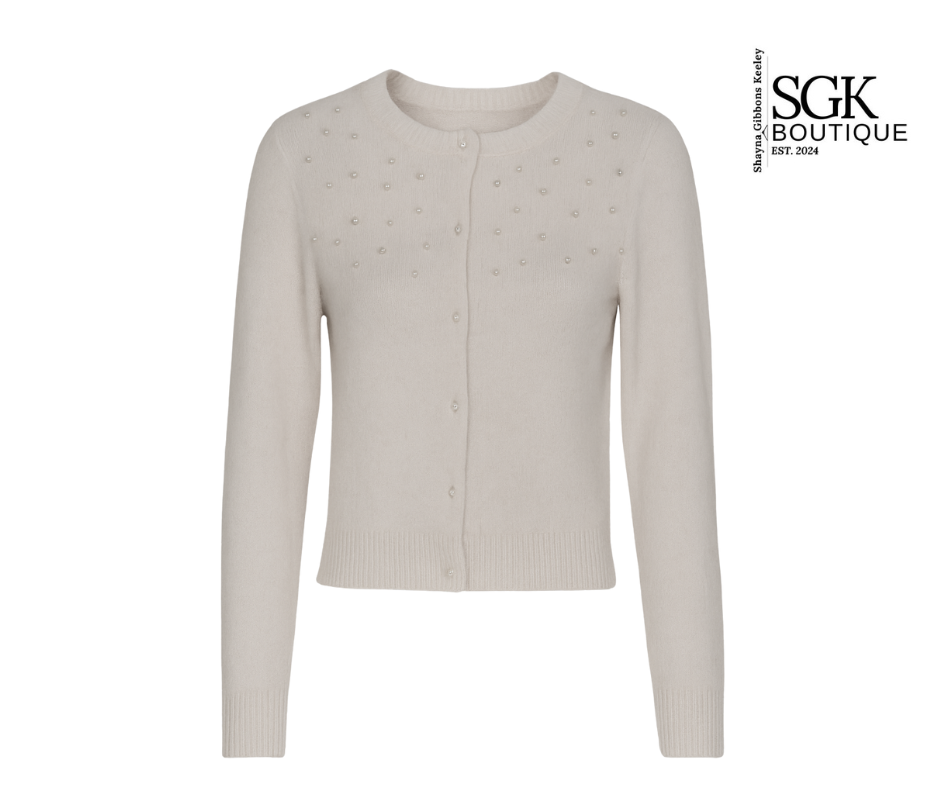 Ivory cardigan with star patterns on a white background, featuring the SGK Boutique logo.