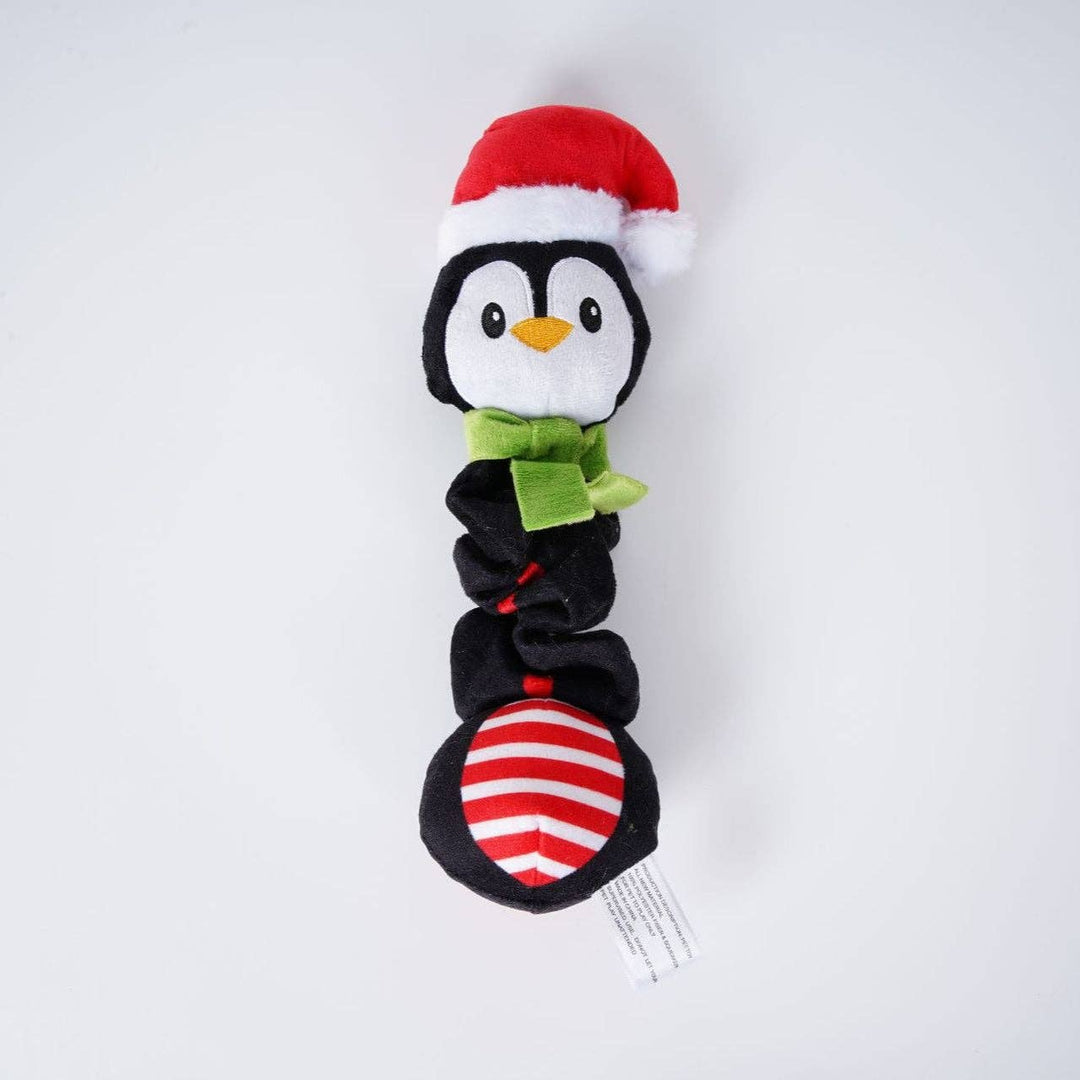 Plush penguin toy with a Santa hat and green bow tie on a white background