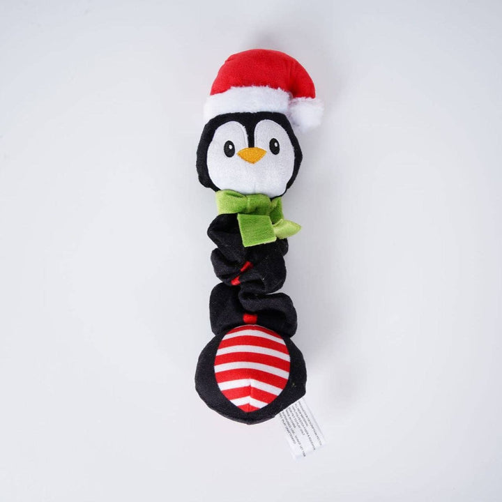 Plush penguin toy with a Santa hat and green bow tie on a white background