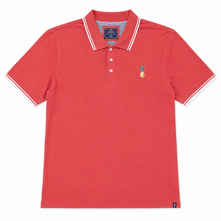 Pinkish polo shirt with a pineapple emblem on a white background