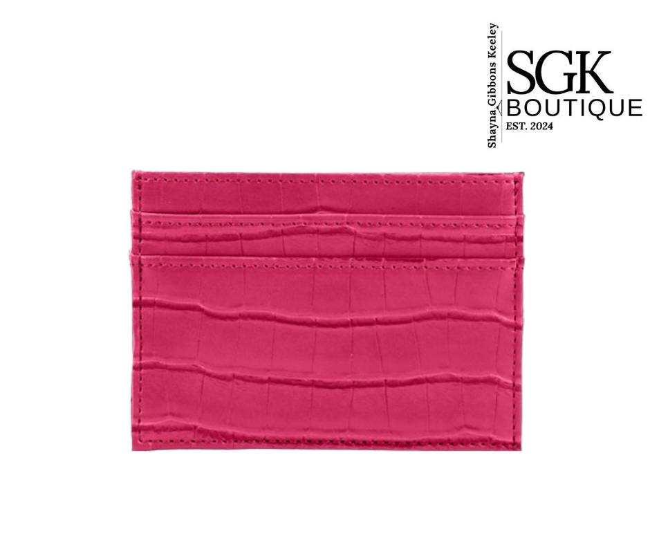 Pink crocodile-textured cardholder with SGK Boutique branding on a white background