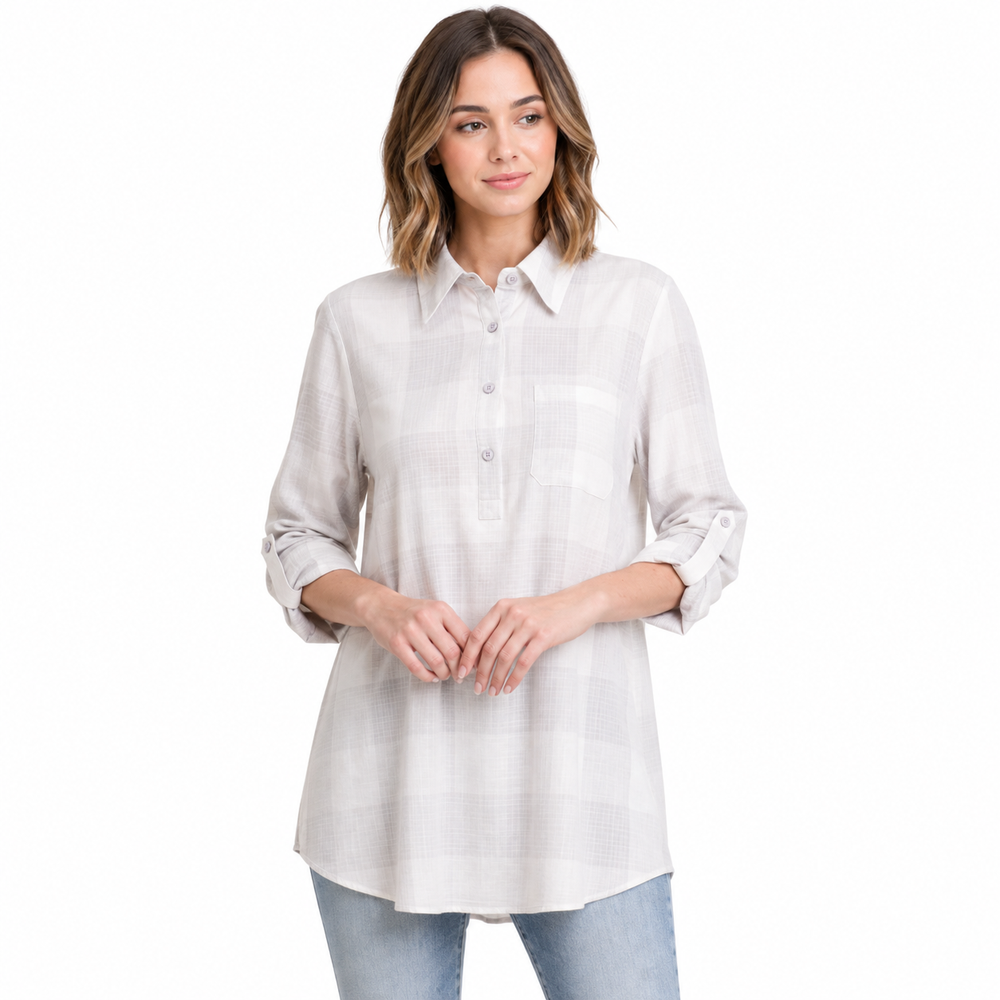 A woman modeling a light beige and white plaid button-down shirt with three-quarter sleeves, paired with light-wash blue jeans, against a solid white background.