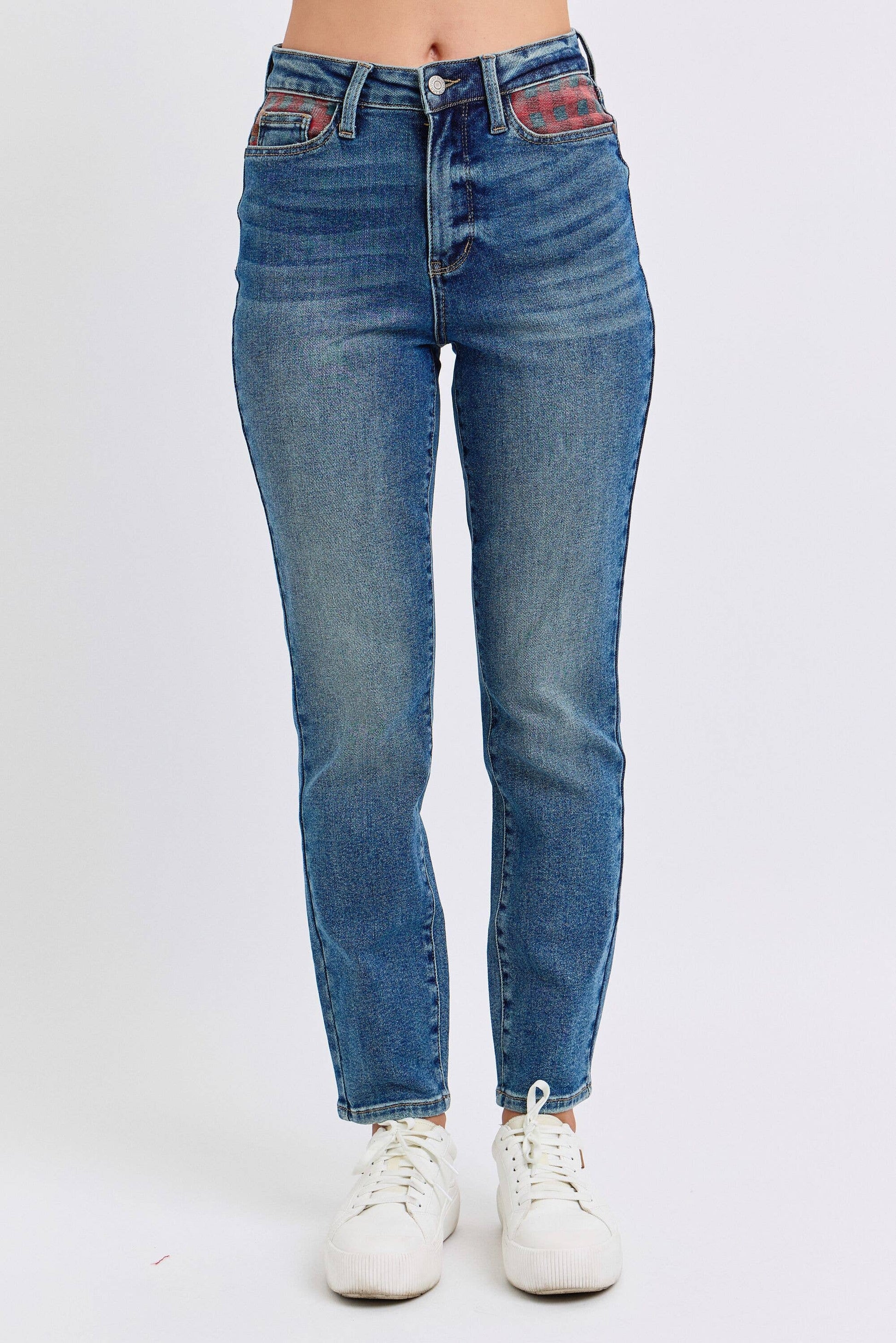 Blue jeans worn by a person on a white background