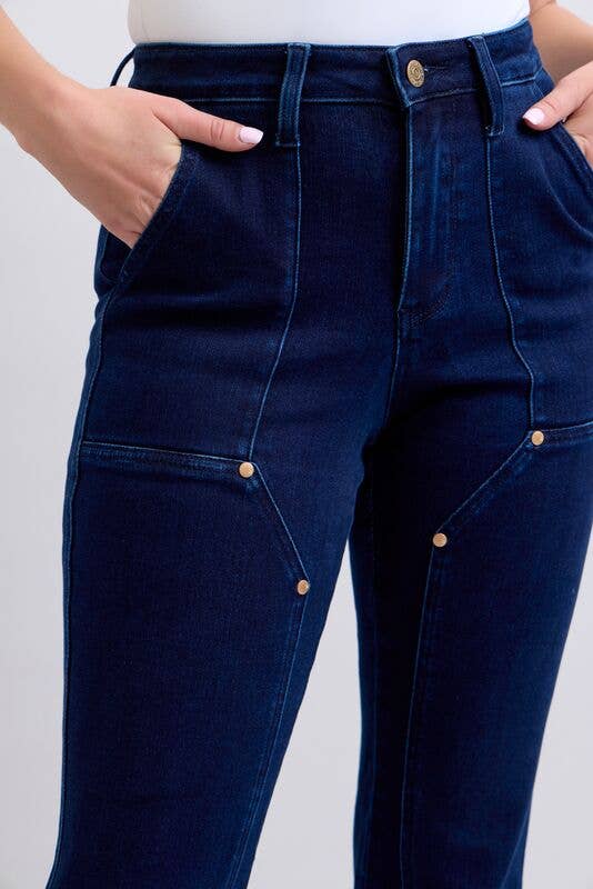 Navy blue jeans with gold buttons on a white background
