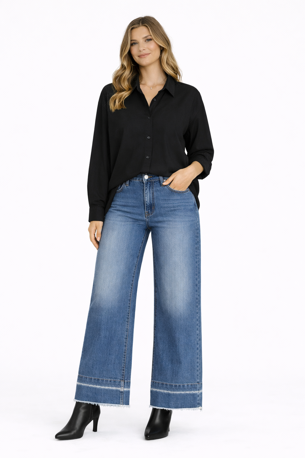 Woman wearing a black shirt and blue jeans on a white background