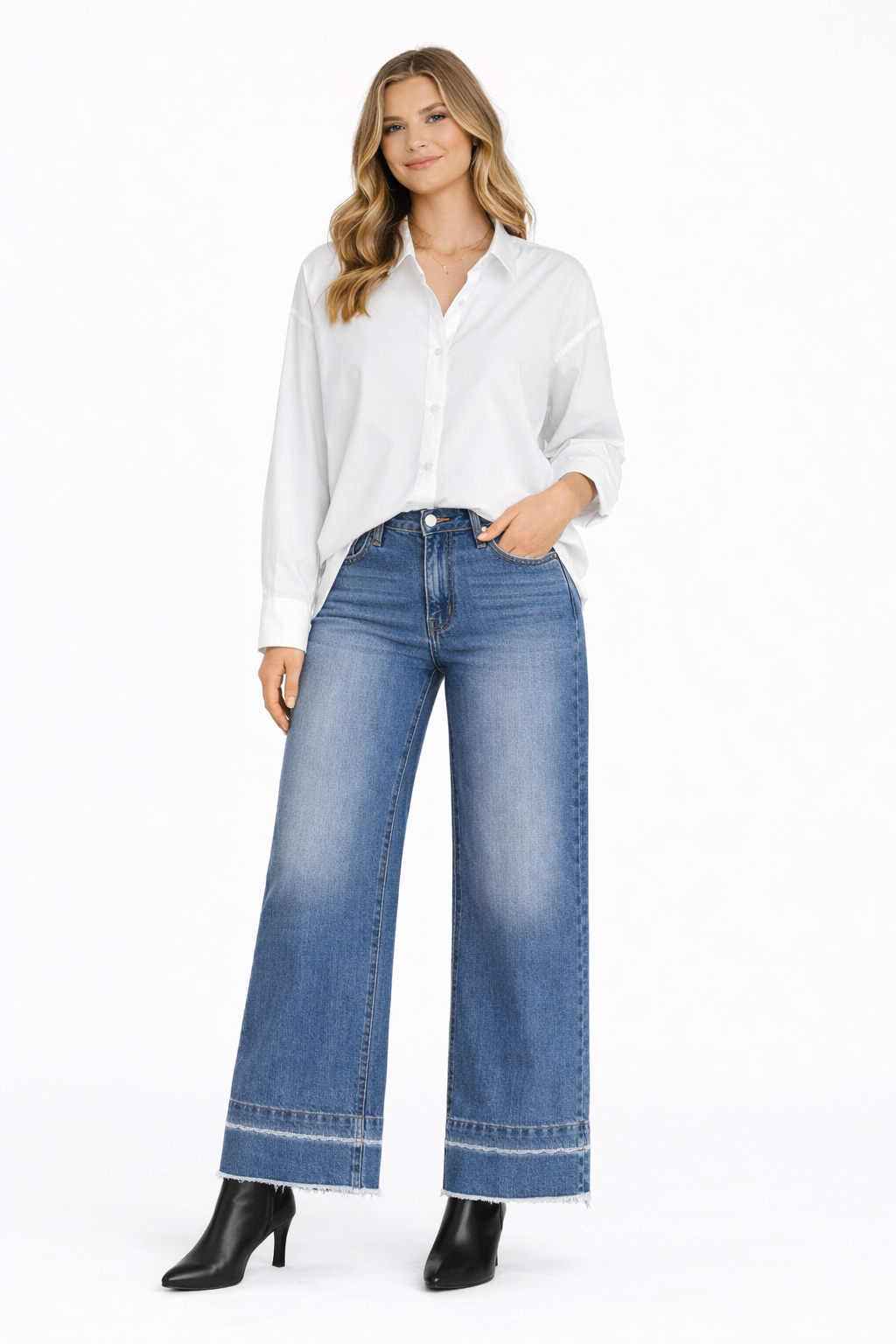 Woman wearing a white shirt and blue jeans on a white background