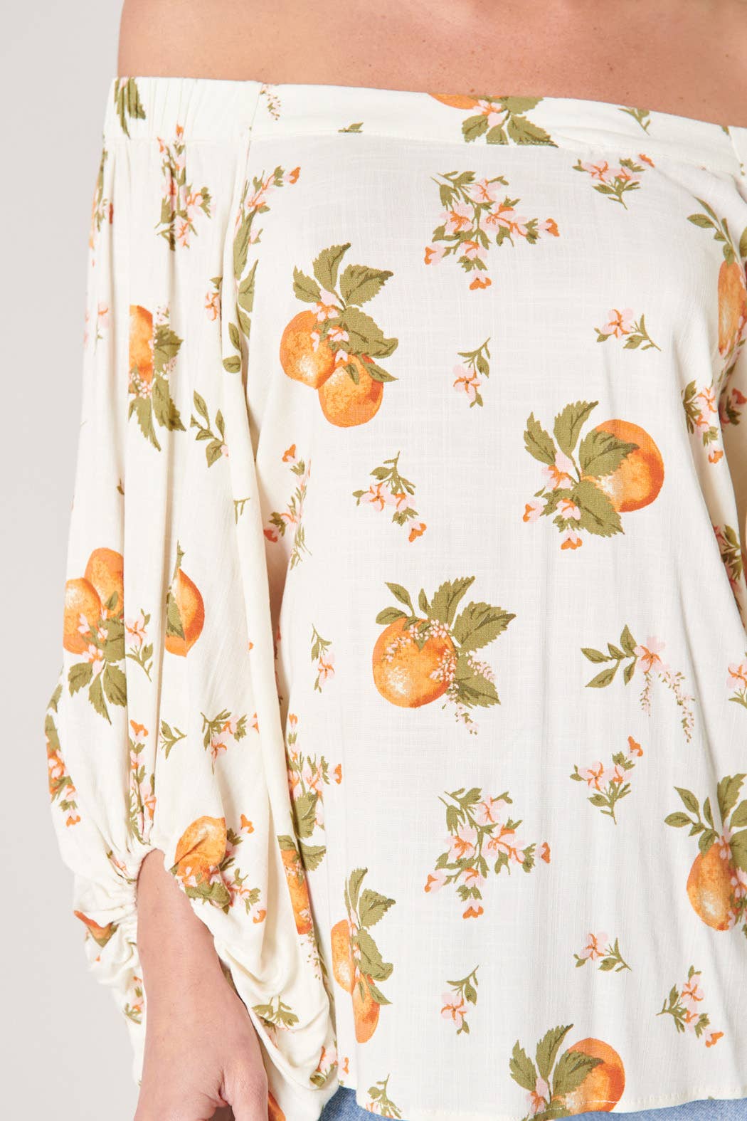 White fabric with orange and green floral pattern