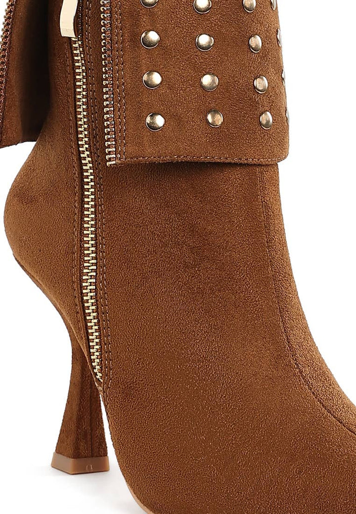 Brown suede boot with studded details on a white background