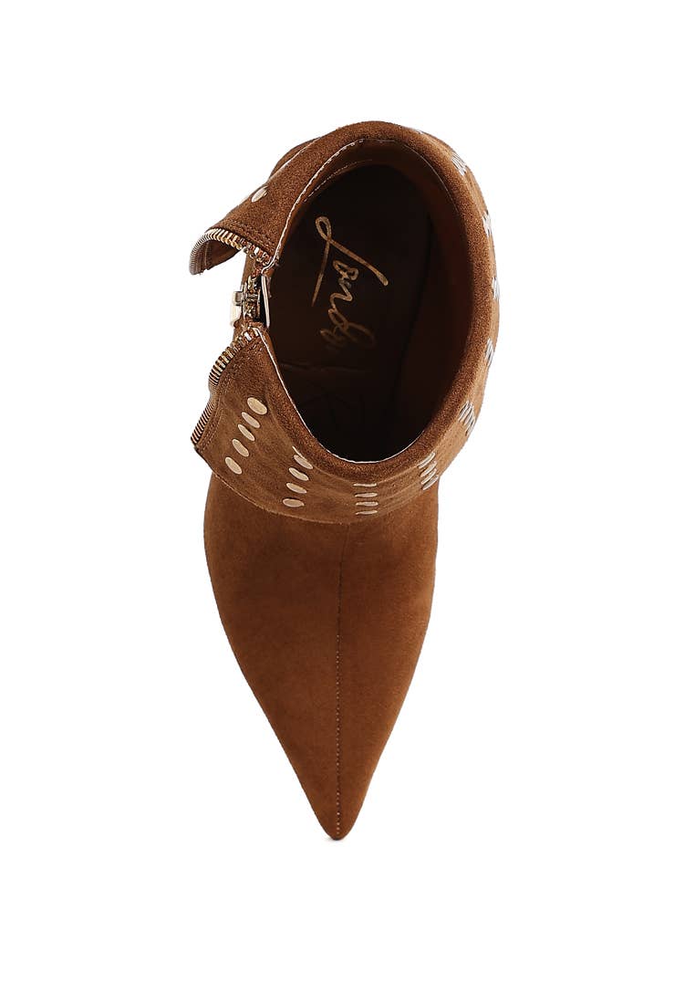 Brown pointed-toe shoe with decorative cutout design on a white background