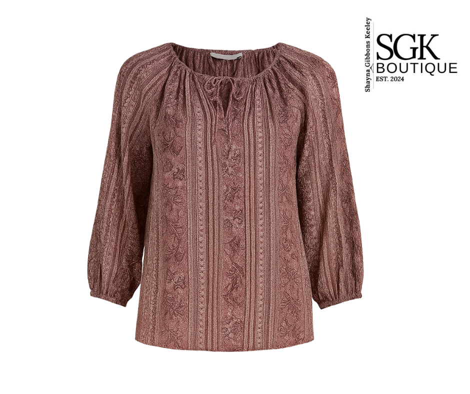Patterned blouse with long sleeves on a white background, featuring the SGK Boutique logo.