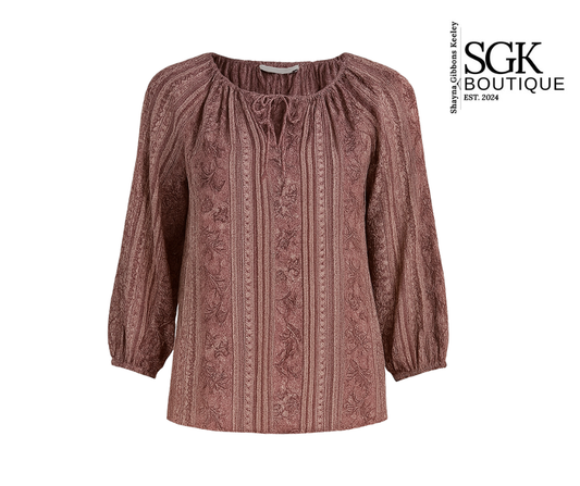 Patterned blouse with long sleeves on a white background, featuring the SGK Boutique logo.